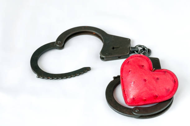 istock Red heart in handcuffs on a white background 648784922