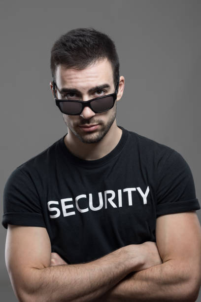 istock Angry tough male security guard with threatening look above sunglasse 648786780