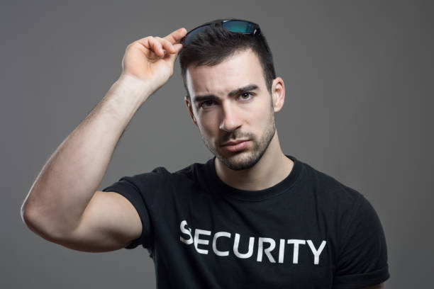 istock Tough security man taking off sunglasses with stare at camera 648787056