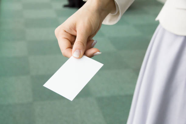 Woman is holding her name card. She and I met for the first time. Close-up.