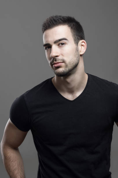 istock Confident athletic man wearing black t-shirt looking at camera suspiciously 648793070