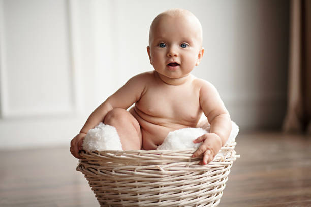 istock Small baby sits in a wicker basket. 648793166