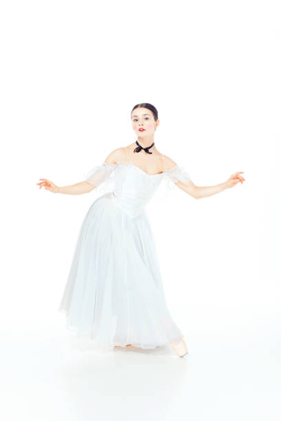 istock Ballerina in white dress posing on pointe shoes, studio background 648793982