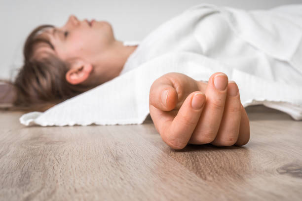 istock Dead woman lying on the floor under white cloth 648794004