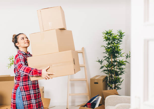 istock New beginings, woman unpacking at home 648798988
