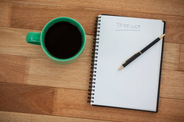 istock Close-up of coffee mug with diary and pen 648803060