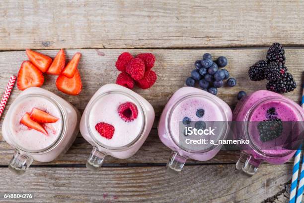 Selection Of Colorful Detox Berry Drinks On Wood Background Stock Photo - Download Image Now