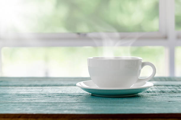 istock Hot cup of coffee on blue wooden table. 648809222