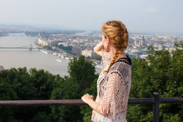 istock Young redhead woman enjoying Budapest panorama 648810178
