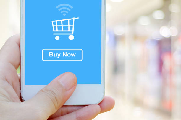 istock Hand holding smart phone with online shopping device on screen over blur store background 648810258