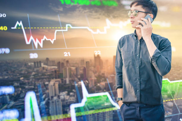 istock Young business man using laptop and digital tablet cityscape background 648818968