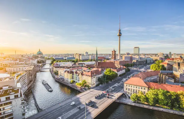 Aerial view of Berlin skyline with famous TV tower and Spree river in beautiful evening light at sunset with retro vintage Instagram style grunge pastel toned filter effect, Germany