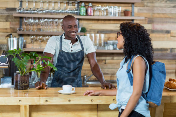 istock Woman interacting with waiter at counter 648821808