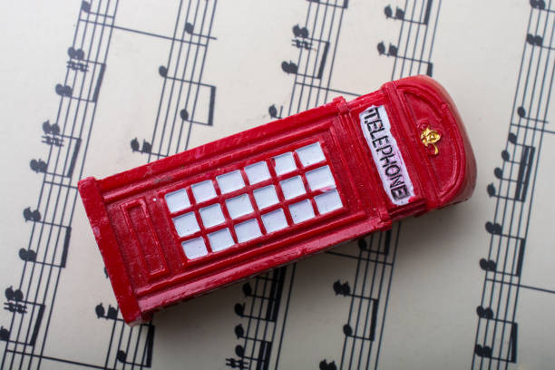 istock Telephone booth placed on paper with musical notes 648822334