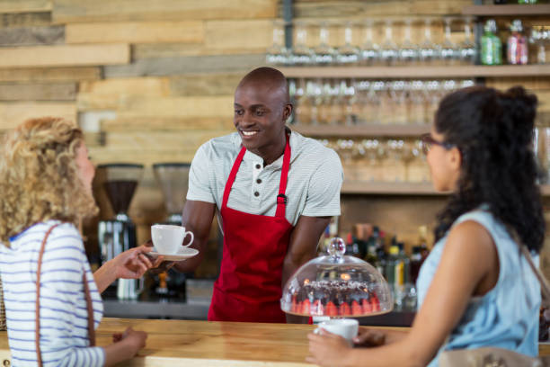 istock Waiter serving coffee to female customer 648825226