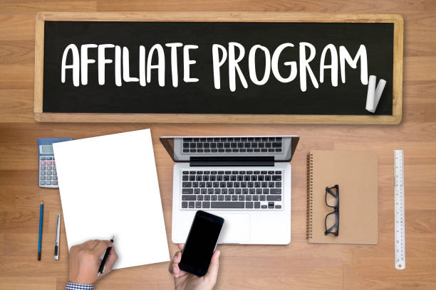 istock AFFILIATE PROGRAM Thoughtful male person looking to the digital tablet screen, laptop screen,Silhouette and filter sun 648825306