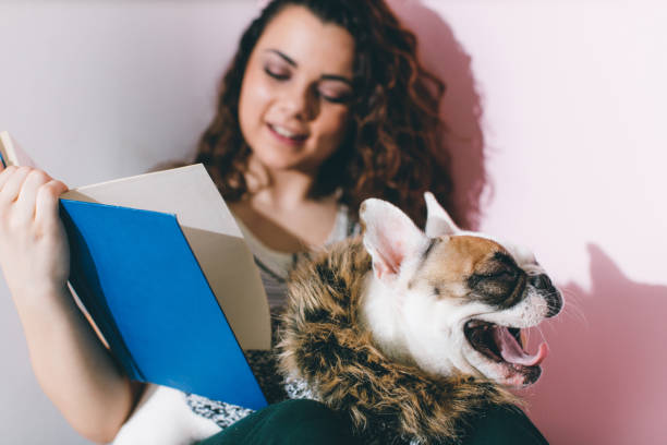 istock Woman is sitting down on the floor with white dog 648825982