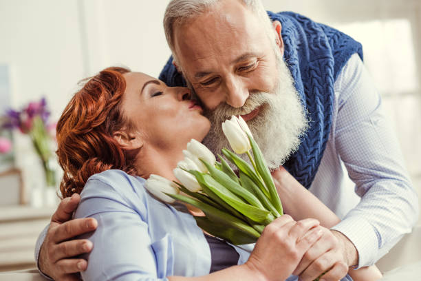 istock Mature couple with flowers 648825996