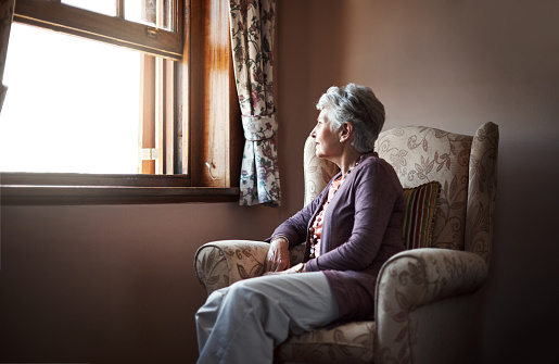 Shot of a senior woman sitting alone in her living room