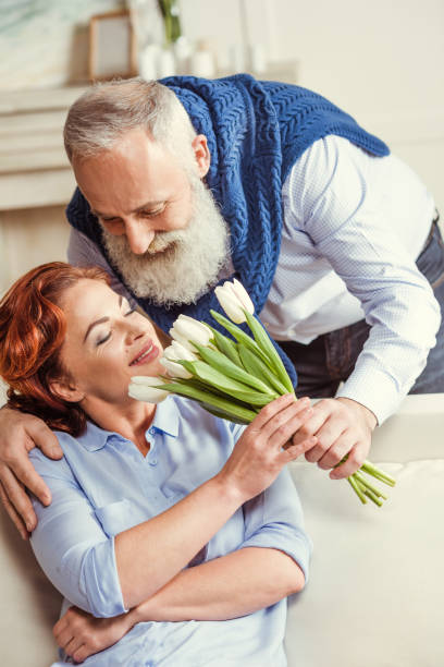 istock Mature couple with flowers 648833374