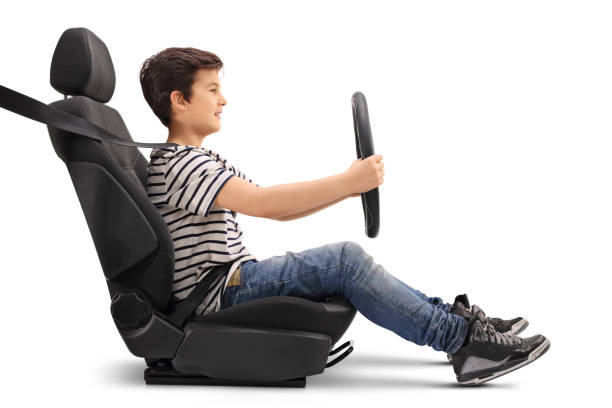 istock Boy sitting on a car seat pretending to drive 648834456