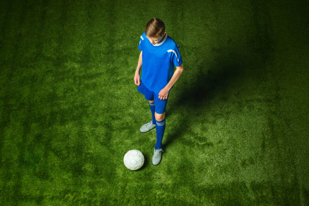 istock Young boy with soccer ball doing flying kick 648840240