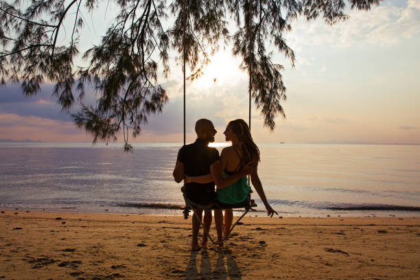 istock Couple on a swing at sunset 648840246