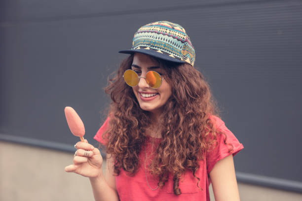 istock Lovely female smiling while eating ice cream 648840768