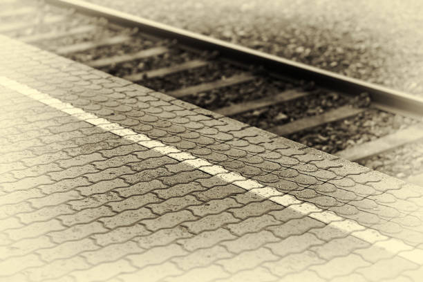 A moody view of railway tracks at dusk, showcasing symmetry and perspective in the environment.