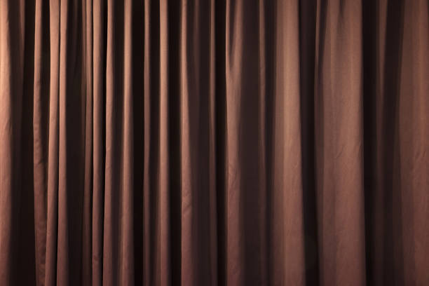 Close-up of closed curtain with light spots in a theater