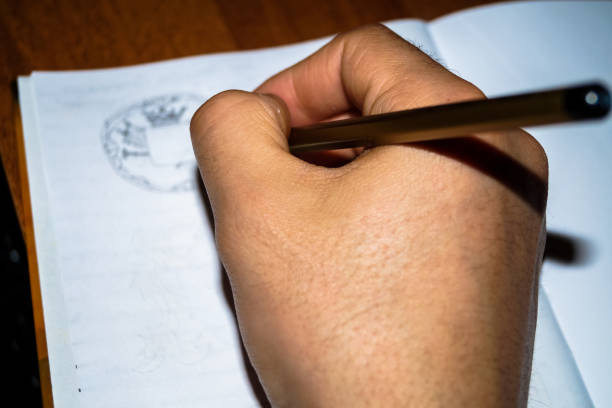 istock Hobbies drawing the human hand holding a pencil 648847064
