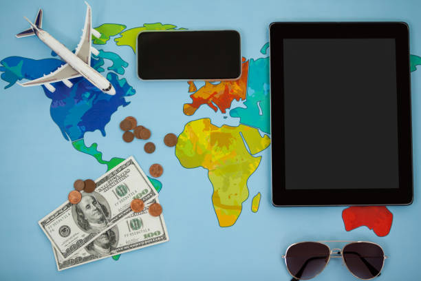 istock Electronic gadgets, sunglasses, dollar and airplane model 648847888