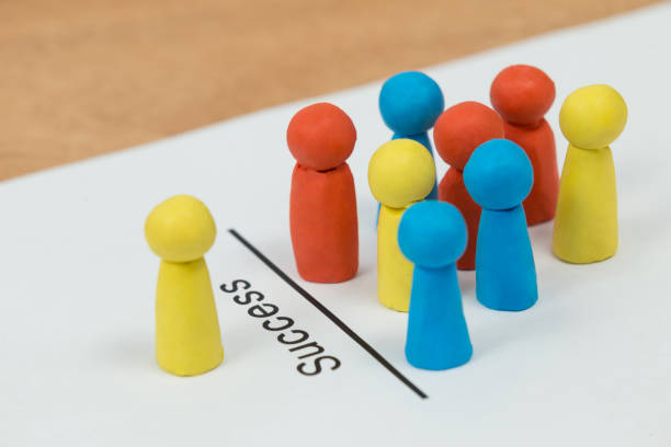 istock Figurines on a paper with text success 648848132