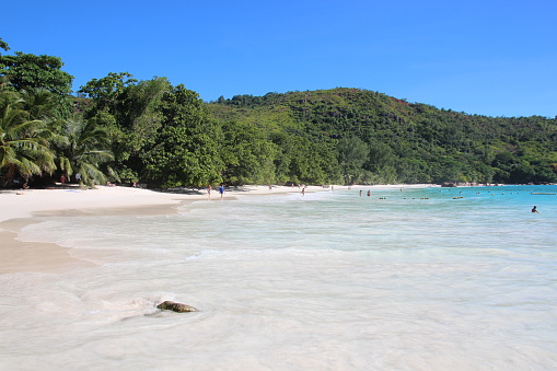 People enjoy the beach Anse Lazio on Praslin Island, Seychelles.\n