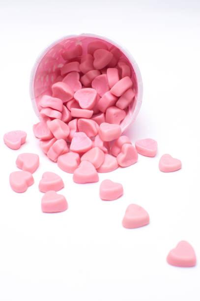 falling heart candy in Pink polka dot paper cups isolated on white background