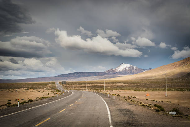 Rural mountain road in Peru, South America, just before the snow storm. Mountains in the background.