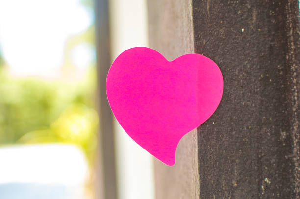 Blank note pad or sticky notes pink with outdoor sunlight background,Happy valentine day.