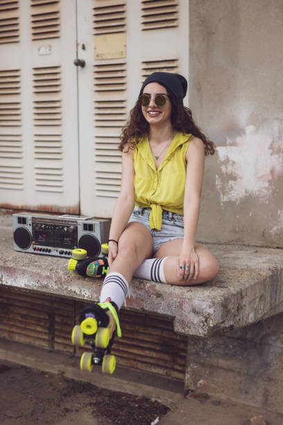 istock Beautiful young brunette, retro roller skates, retro ghetto blaster 648850210