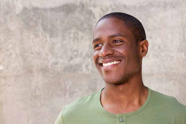 istock Young african american man on gray background smiling 648856158