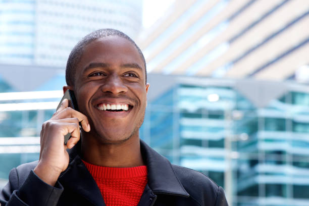 istock Close up happy african guy talking on mobile phone 648856600