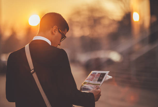 istock Businessman reading newspaper 648856794
