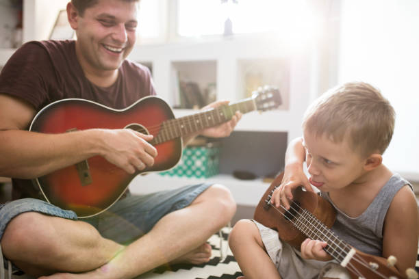 istock Serious rocking out , father and son , lens flare 648857070