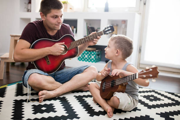 istock Papa playing guitar for his child 648857490