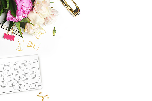 Flower on the table. Keyboard and stapler. Home workplace. Table view. Mock-up background. Peonies