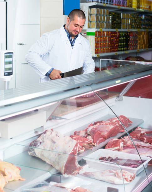 istock butcher cutting fresh lamb meat 648867844