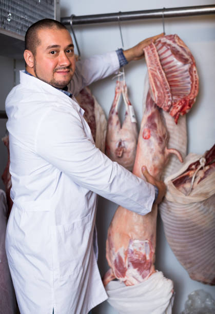 istock butcher working with meat in store 648867848