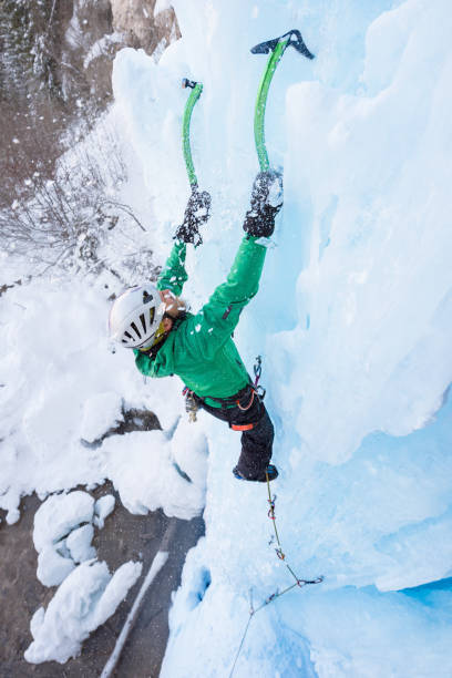 istock Mountaineer holding on ice axes on frozen waterfall 648868040