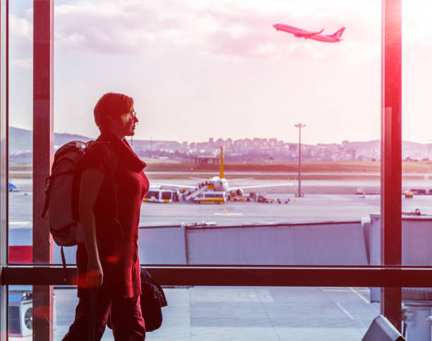 istock Woman with small Backpack walking at Airport 648874538