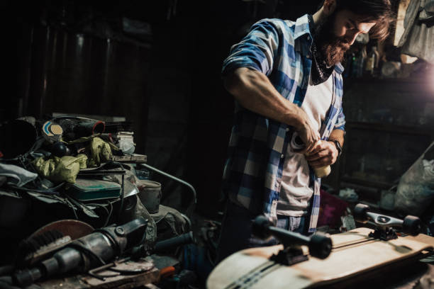 istock Skater adjusting screws on the wheels in his garage 648889442
