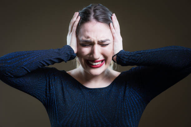 istock Screaming ears closed face. Beautiful girl with red lipstick. 648892006